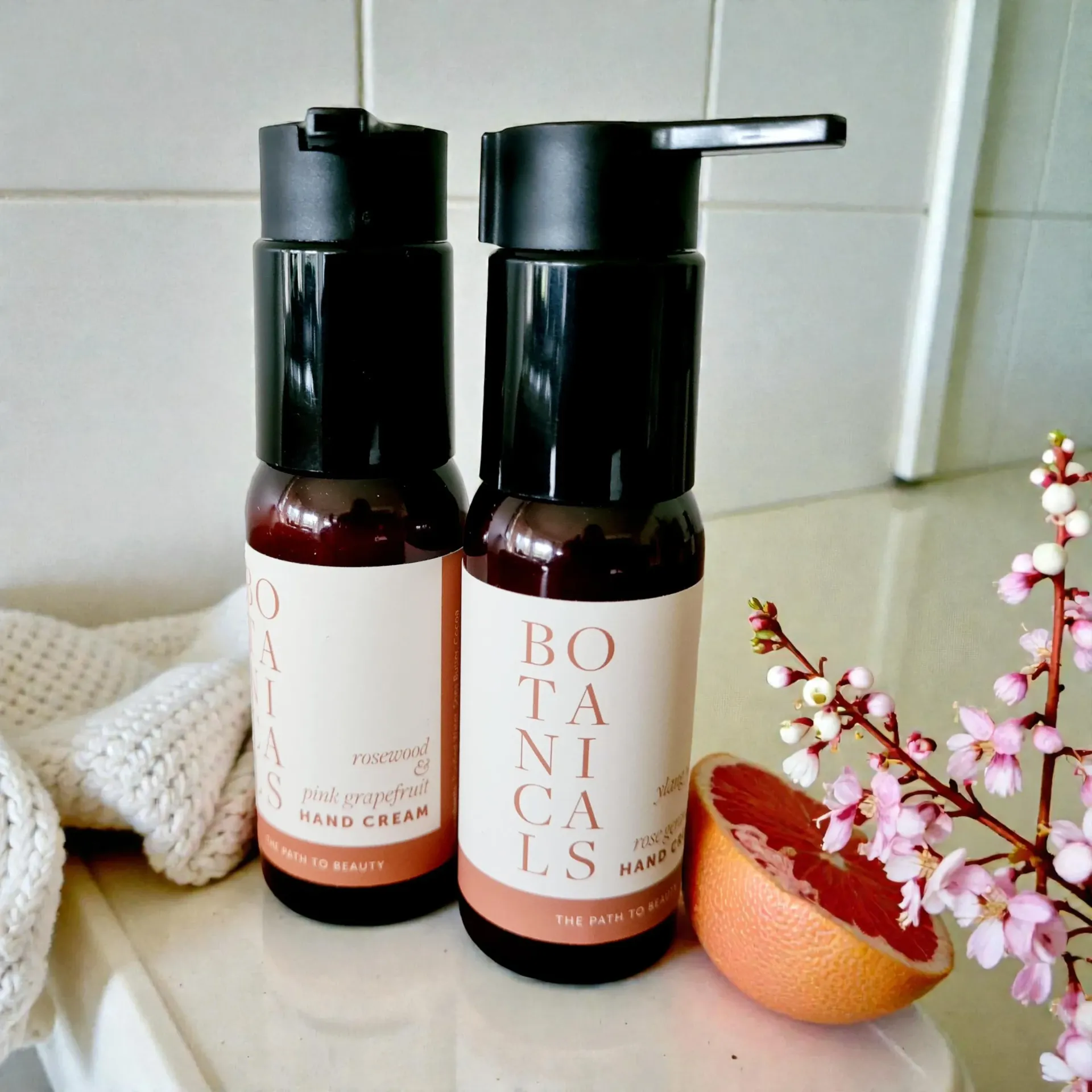 Two brown bottles with black pumps labeled 