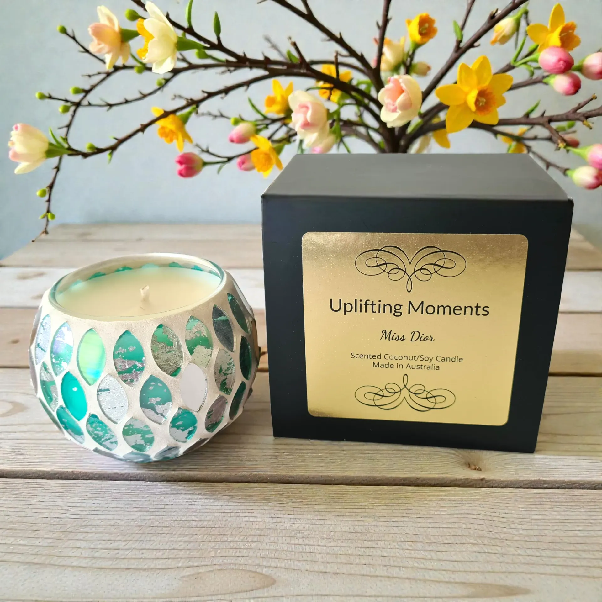 Gift box with rose-themed bath products, surrounded by petals, leaves, and roses.