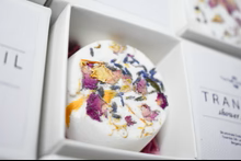 Bath bomb with flower petals in a white box.
