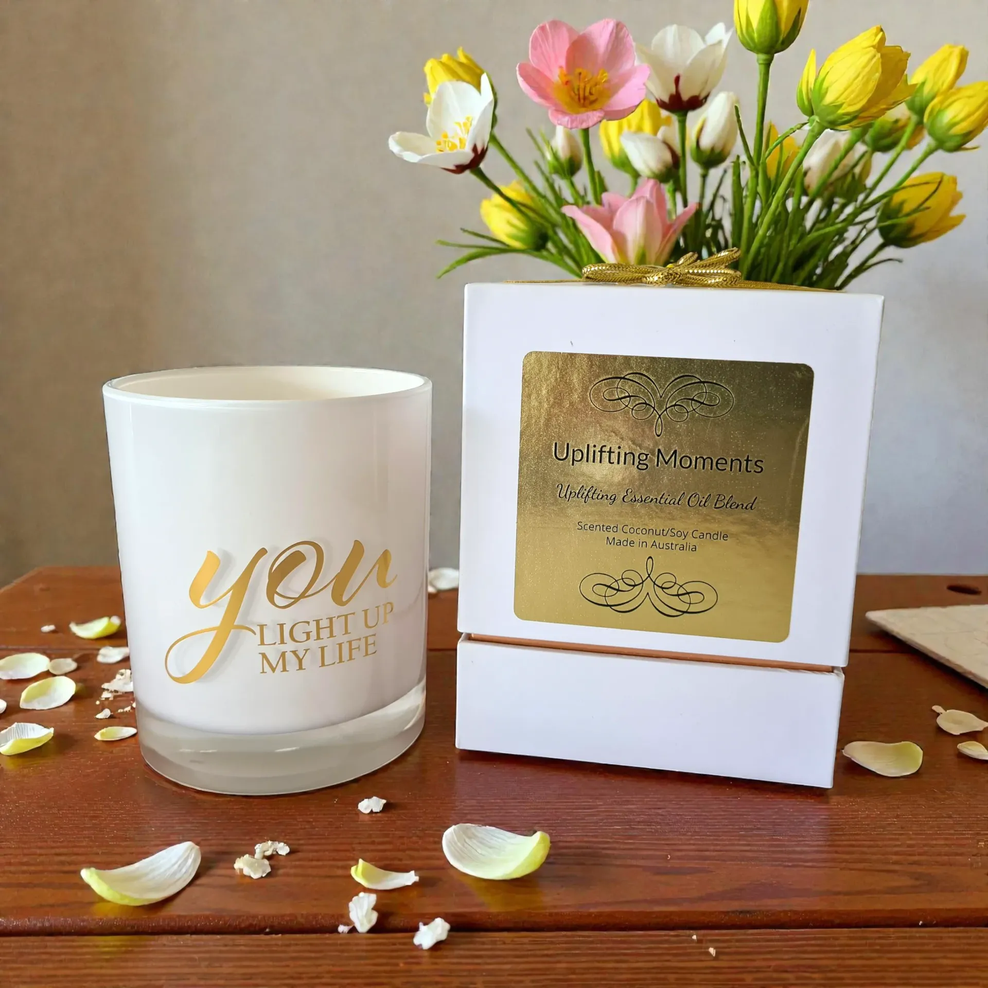 White candle with gold text 