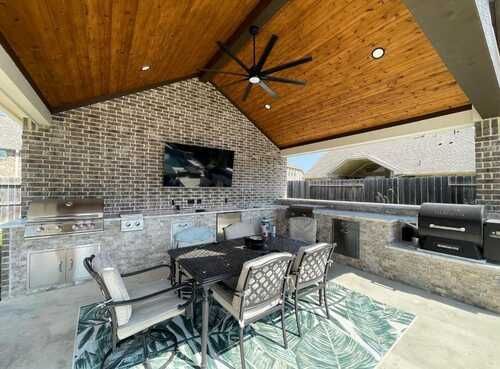 Outdoor home improvement with TV mount and ceiling fan by handyman contractors in DFW