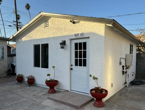 Exterior view of a tiny home, also known as an ADU (Accessory Dwelling Unit) or little house, nestled in a serene natural setting.