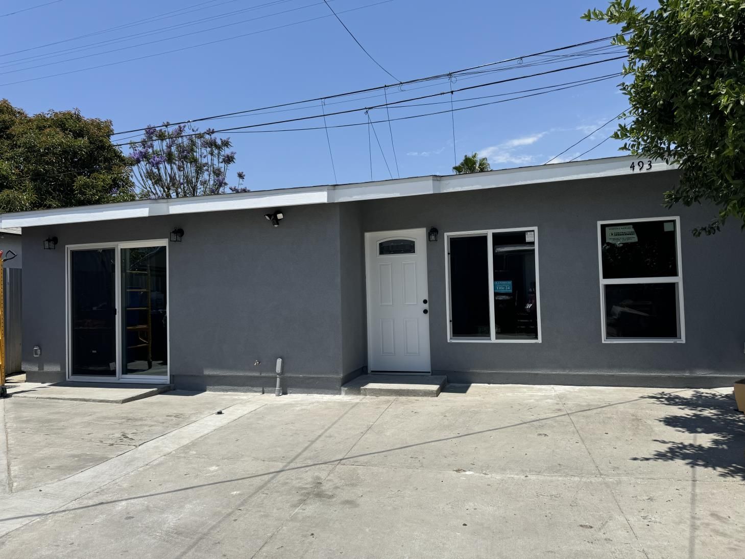 the front of a house with a white garage door