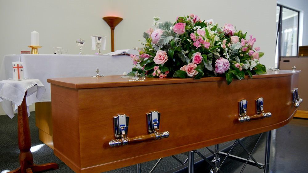 A coffin with flowers for a memorial slideshow