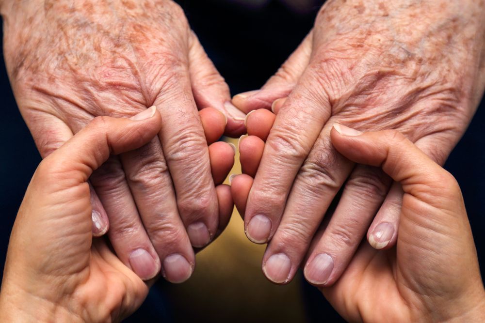 Holding Hands Of An Older Person — Funeral Directors in Sydney & Central Coast, NSW