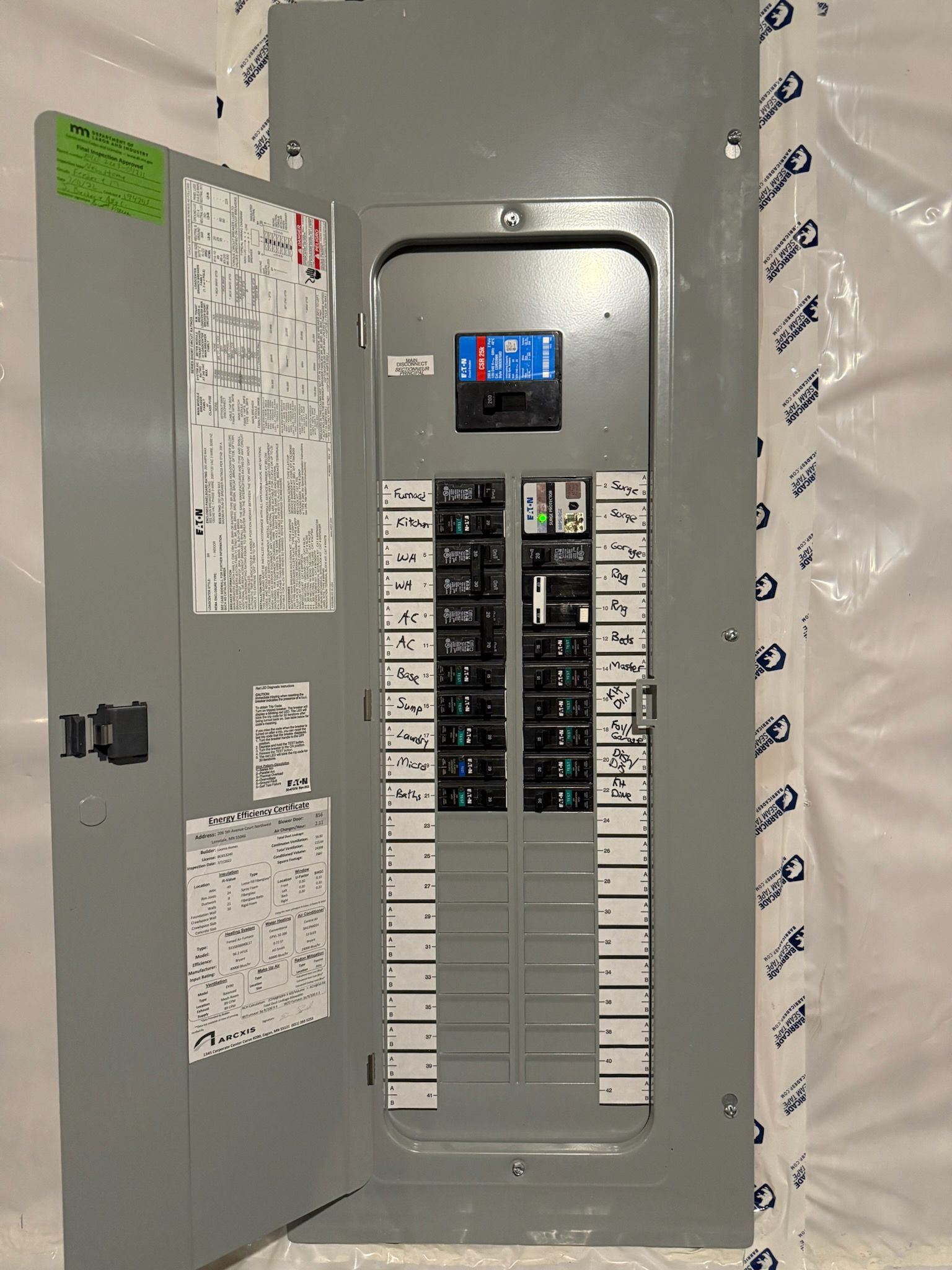 Open electrical control panels with various components mounted inside.