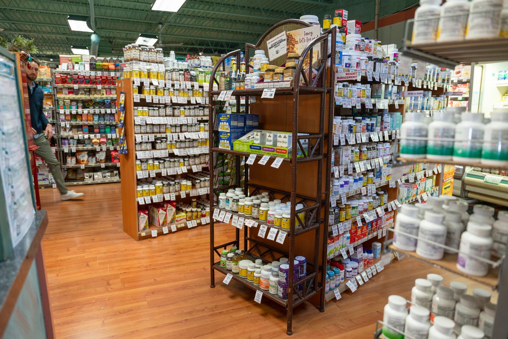 The inside of a pharmacy filled with lots of bottles and shelves.