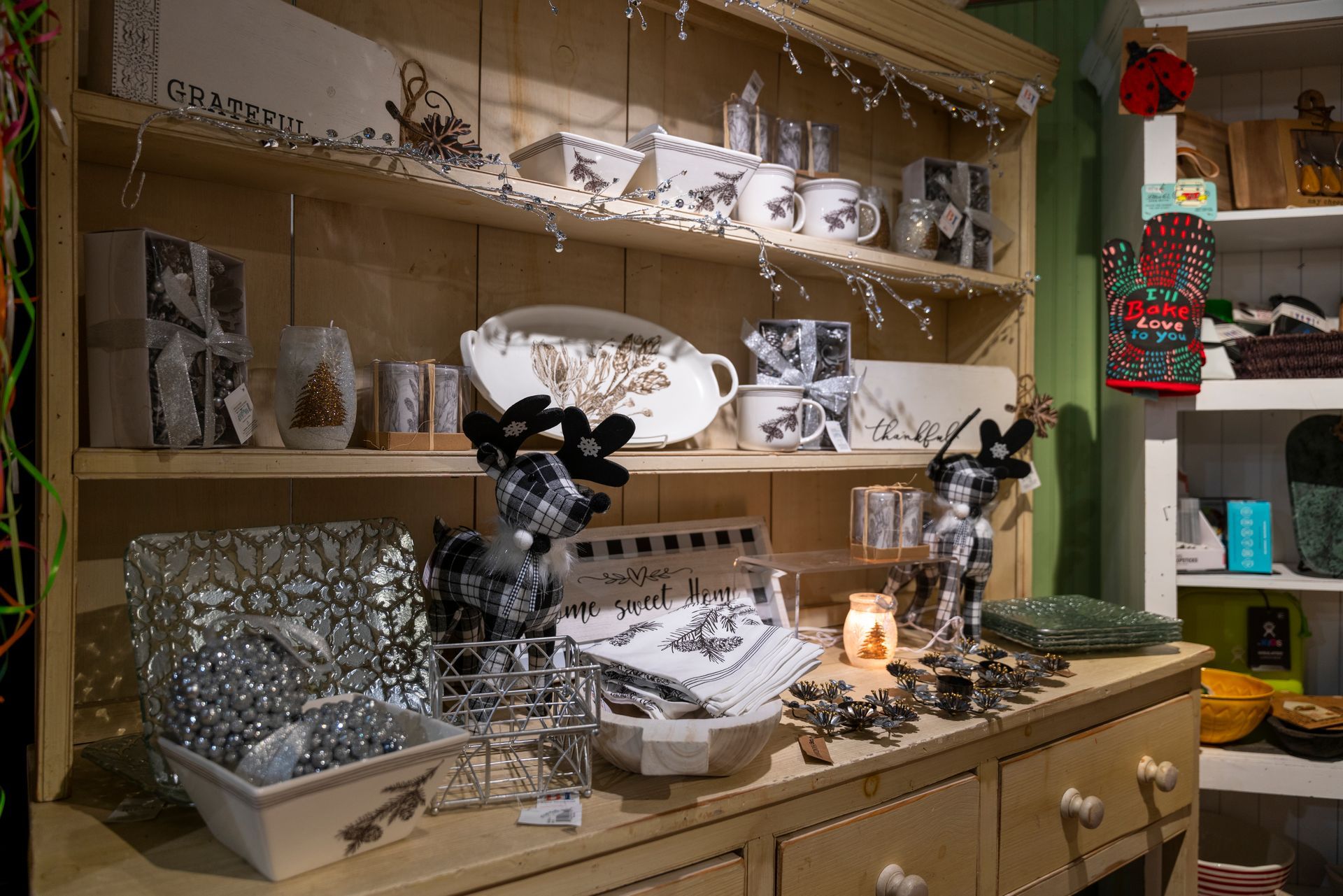 A wooden hutch filled with lots of christmas decorations.