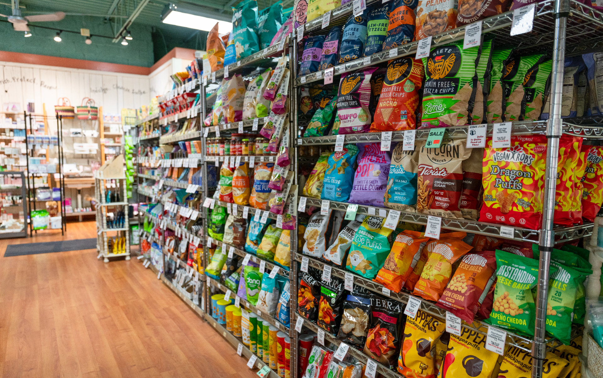A grocery store aisle filled with bags of chips.