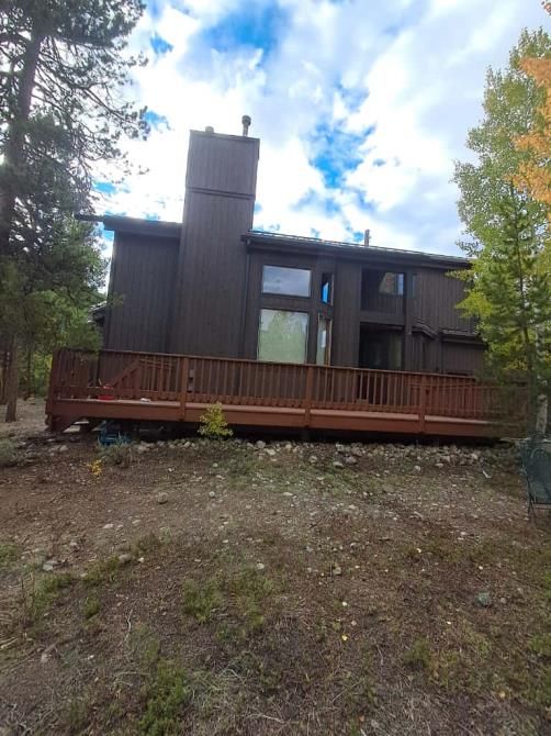 a house with a large deck and sliding glass doors