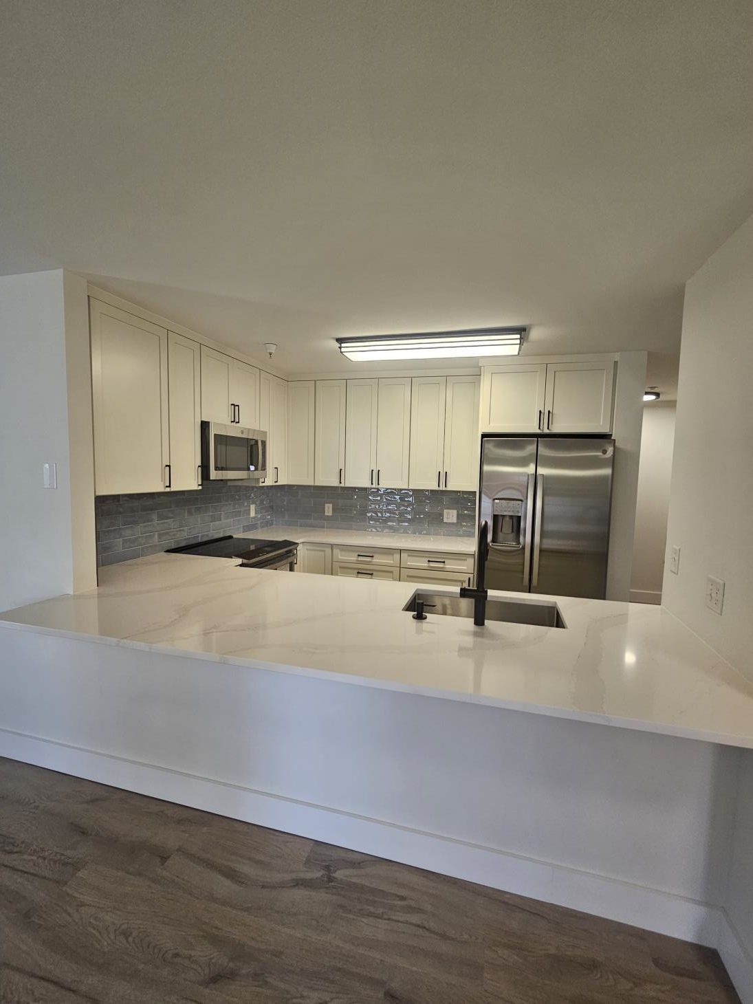 a kitchen with a large island in the middle of the room .