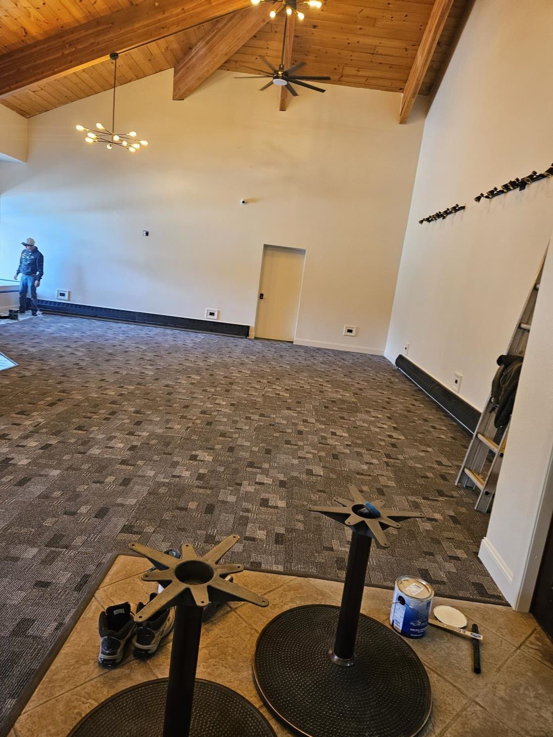 a man paints a wall with a paint roller