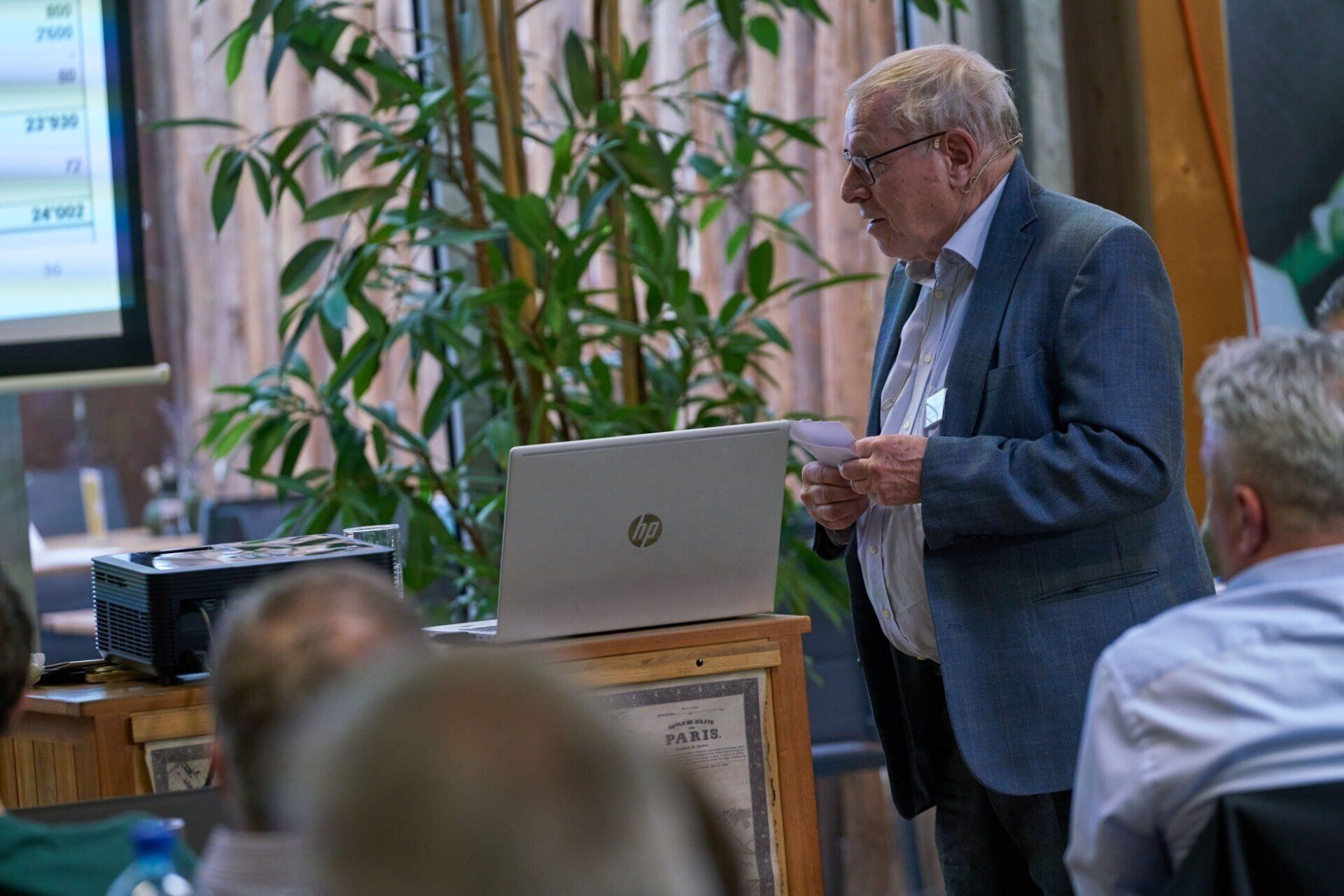 Ein Mann hält vor einem Laptop eine Präsentation.