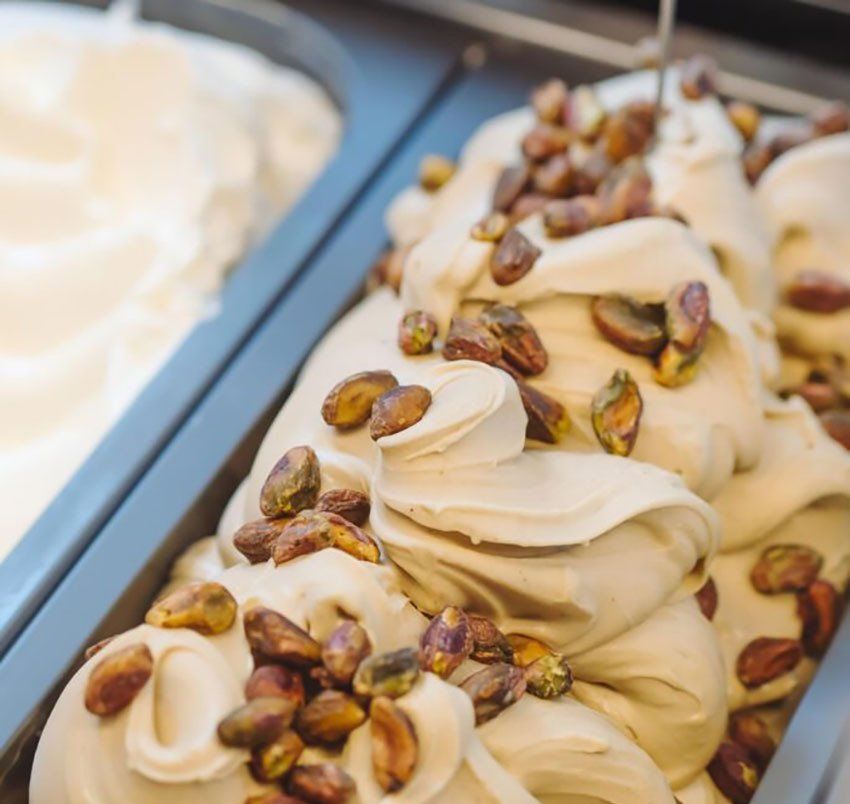 Ein Becher Eiscreme mit Pistazien obendrauf