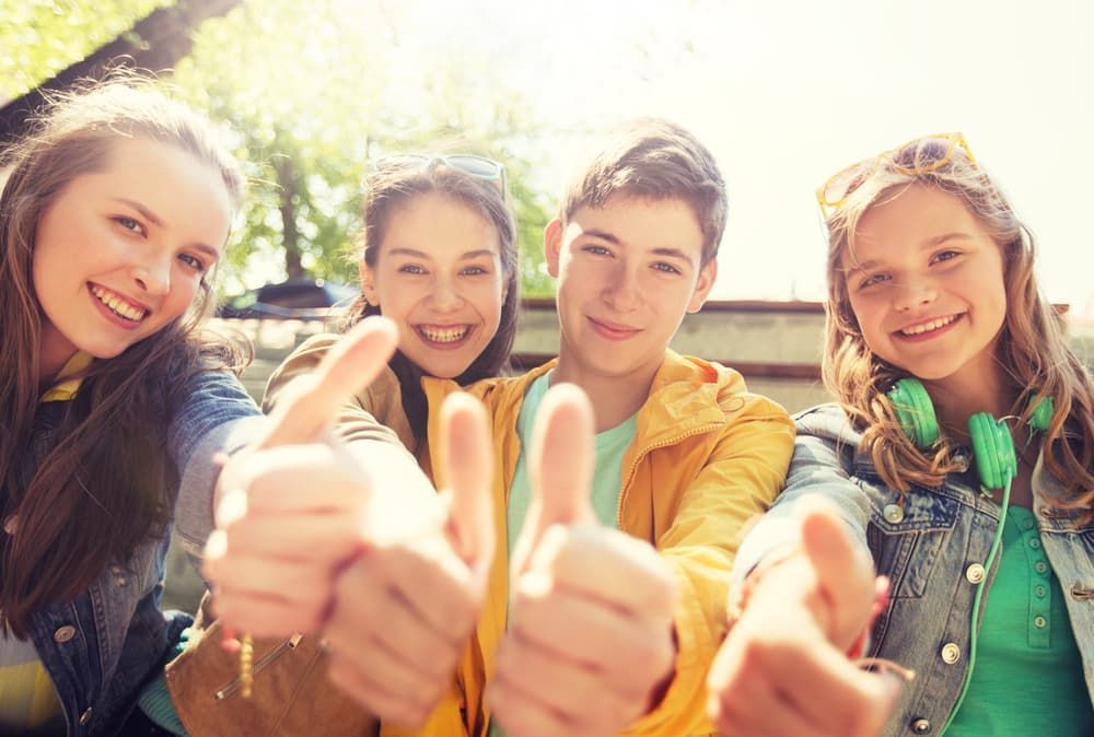 A Group of Young People Are Giving a Thumbs Up Sign — Empowering You Disability Services In Maryborough, QLD