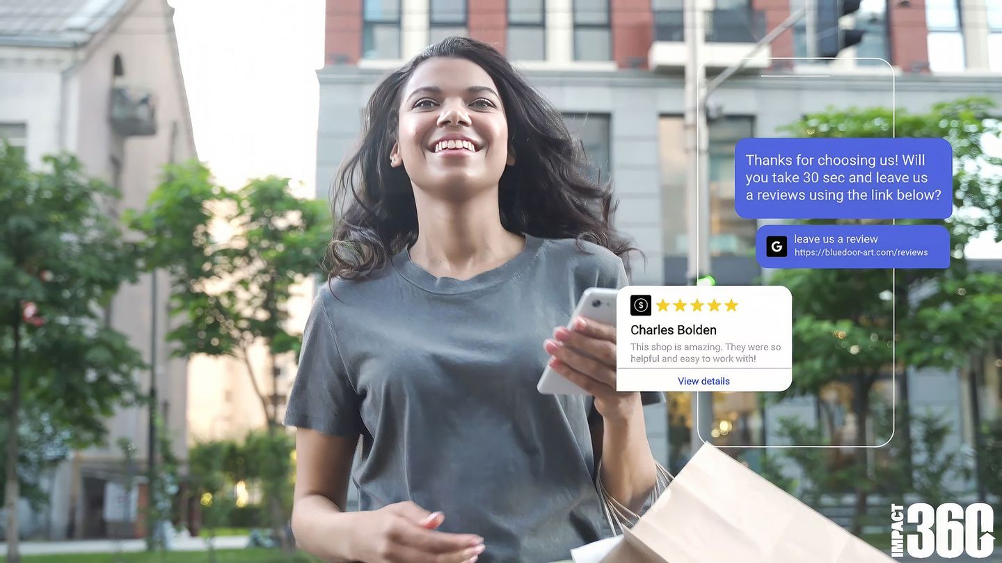 a woman holding a cell phone with a review from charles bolden on it