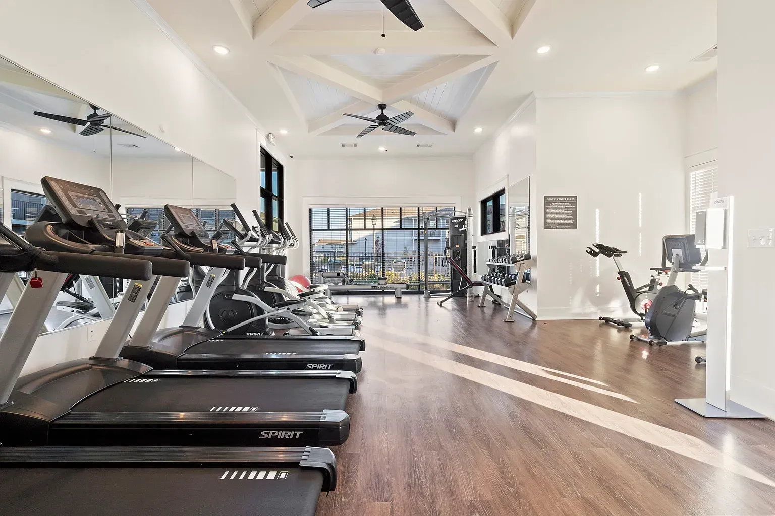 Bright community fitness center with treadmills and weight area at Graces Reserve Apartments in Kannapolis, NC.