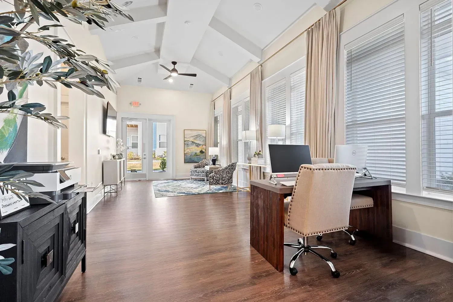 Leasing office lobby with reception desk, seating area, and large windows at Graces Reserve Apartments in Kannapolis, NC.