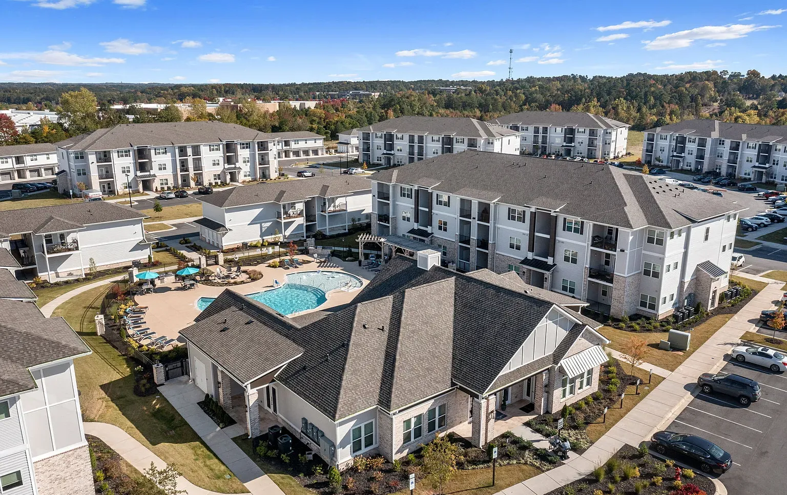 Aerial view of a modern apartment community with a central pool, courtyards, and multiple buildings at Graces Reserve Apartments in Kannapolis, NC.