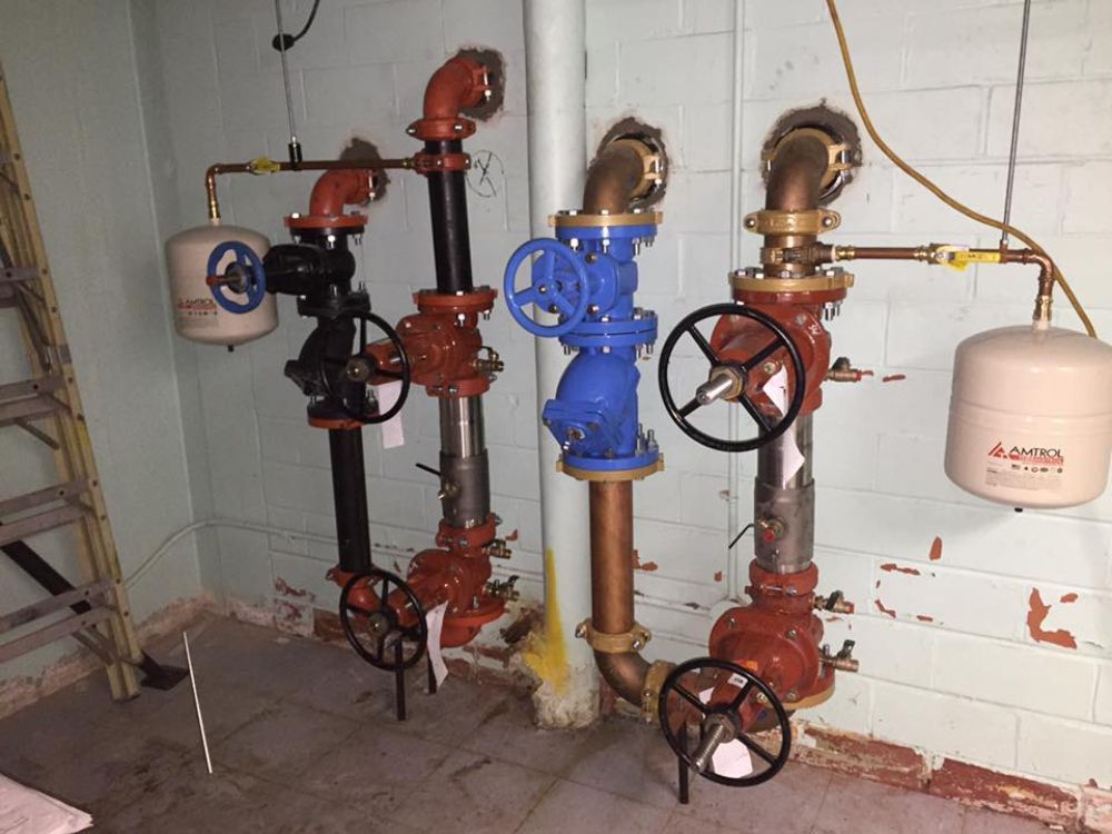 A room with a lot of pipes and valves on the wall