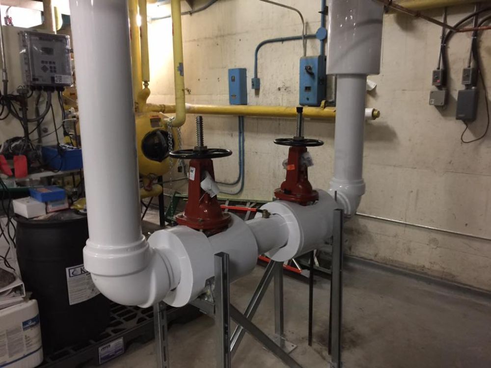 A room with a lot of pipes and valves in it