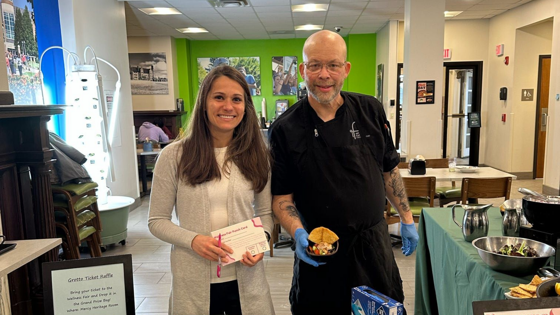 A large group of people are posing for a picture in a room.