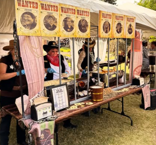 People in costume at a decorated booth.
