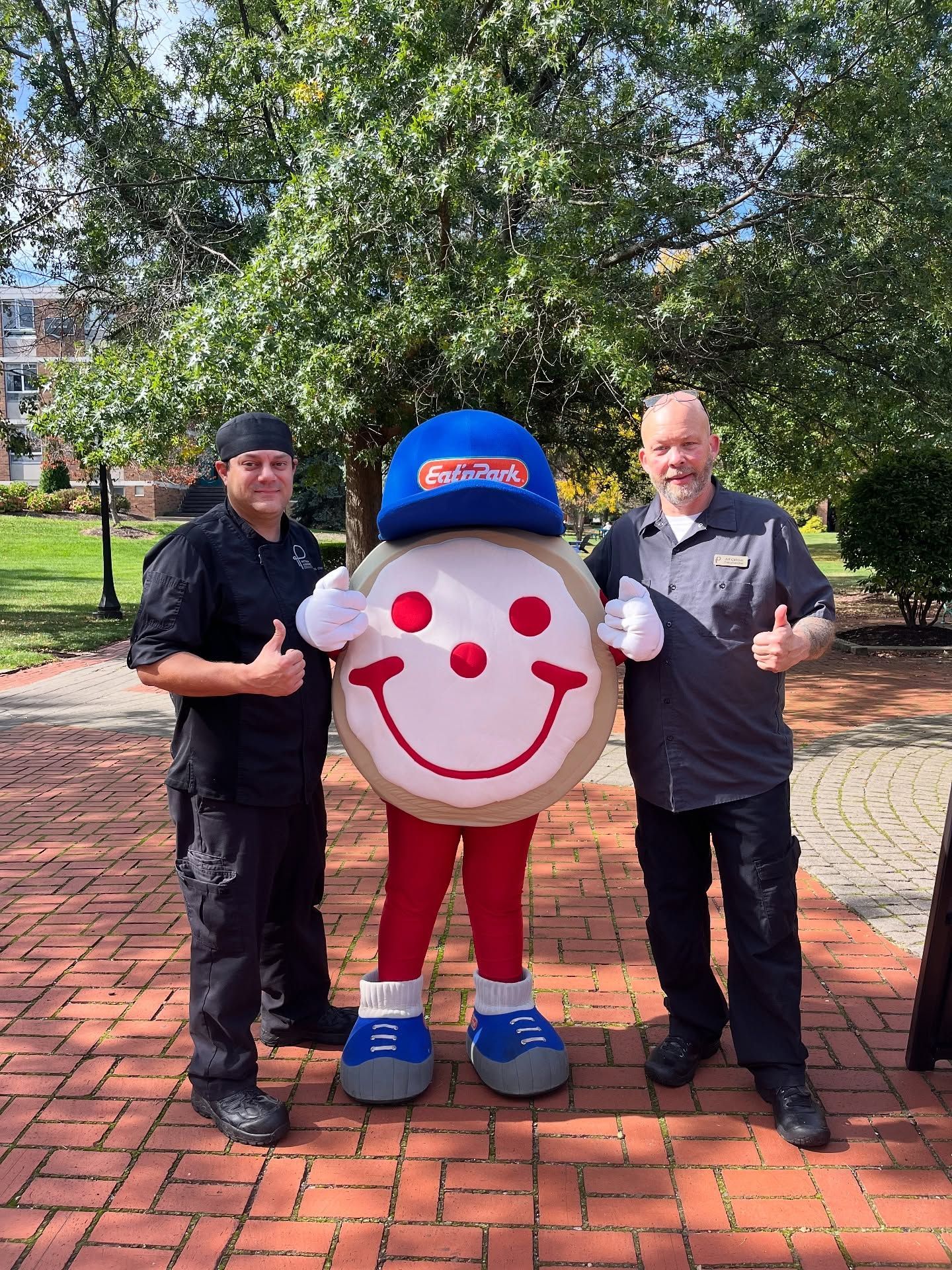 A group of chefs are posing for a picture in a kitchen.
