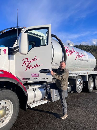A men standing next to a large truck — Eugene, OR — Royal Flush Environmental