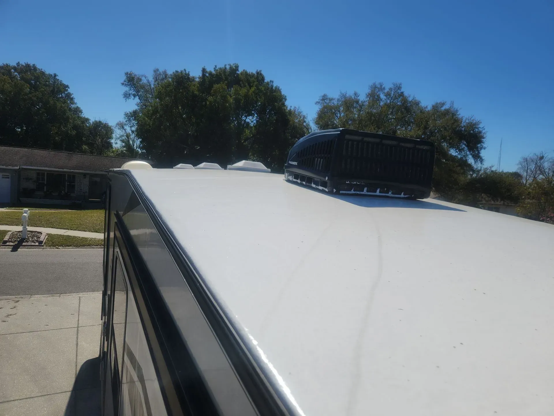 Side by side comparison of silicone roof coating and RV Roofing Solutions maintenance-free system