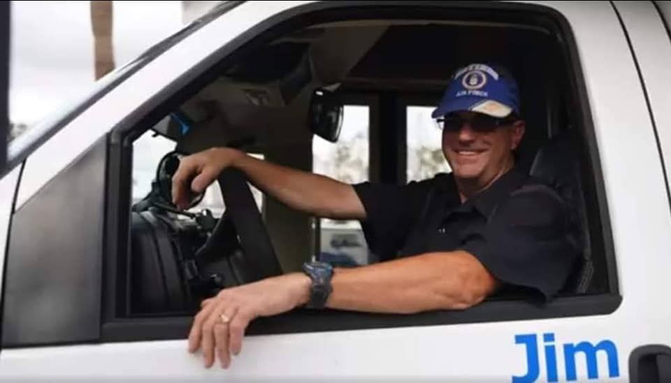 A man is sitting in the driver 's seat of a truck.