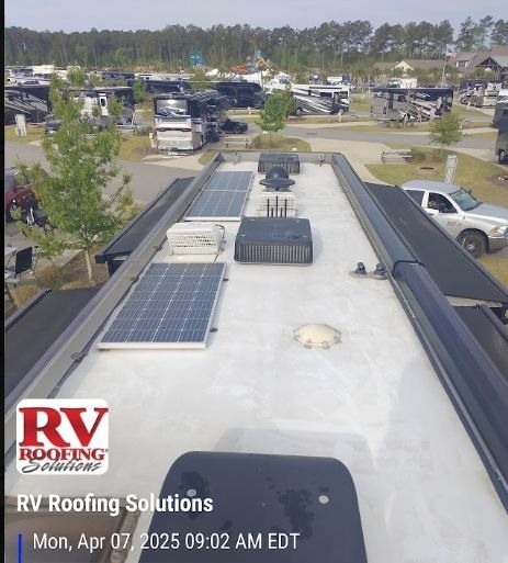 RV roof with solar panels and rooftop vents at an RV park, with RV Roofing Solutions watermark
