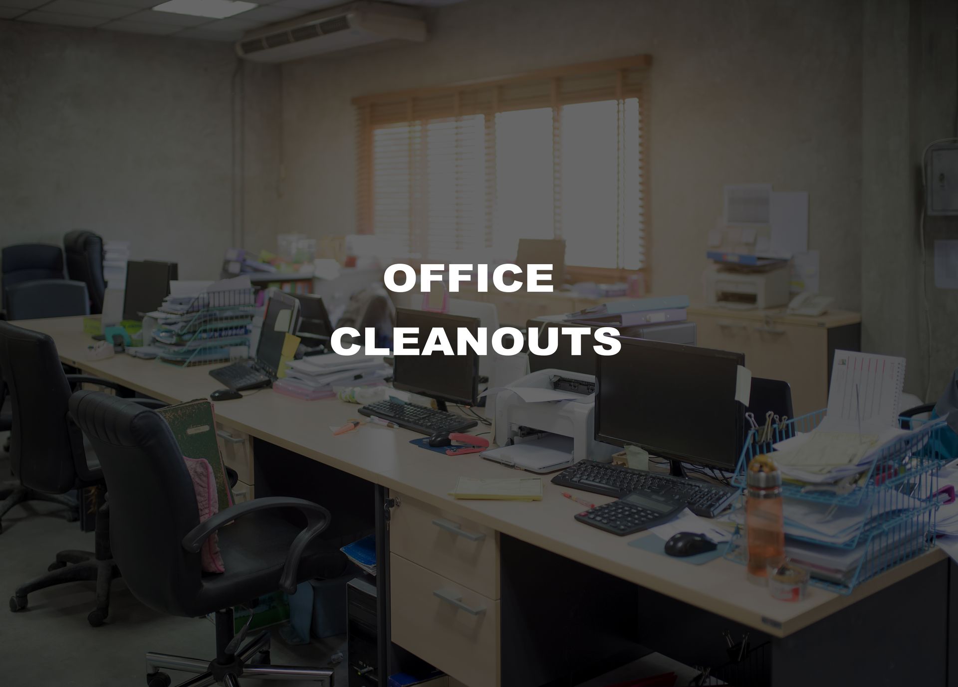 Office desks cluttered with papers, computers, and trash, implying a need for office cleanouts.