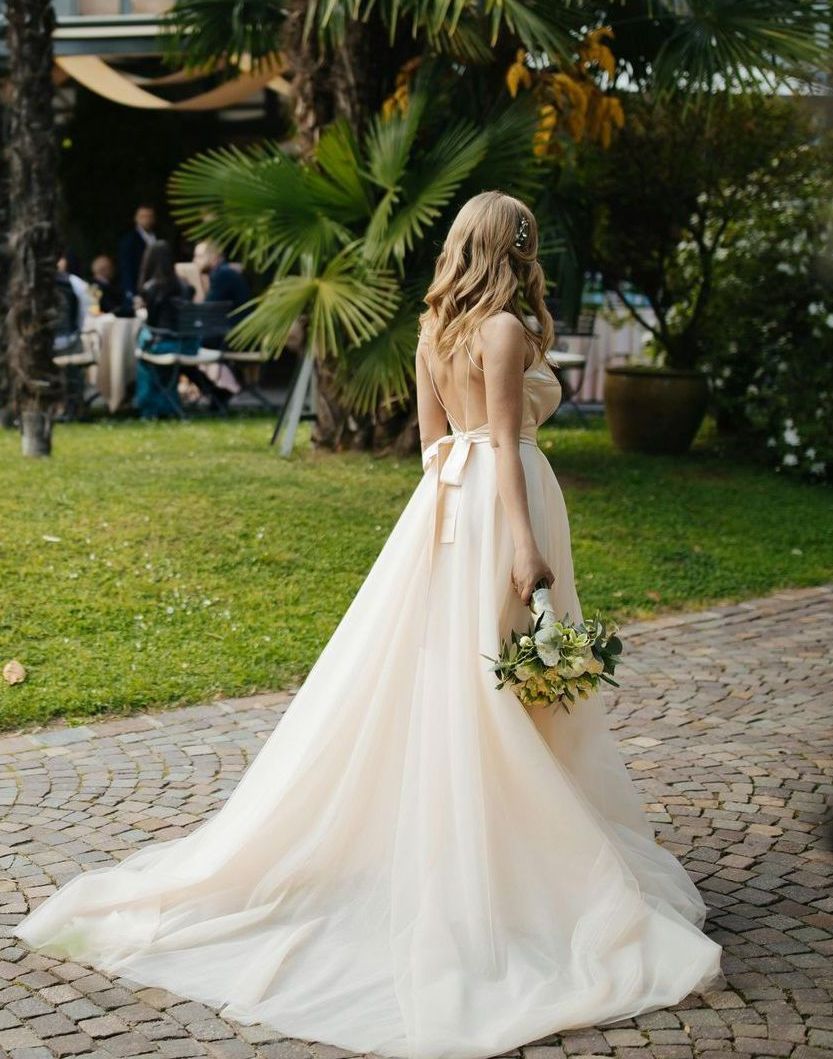 A woman in a wedding dress is holding a bouquet of flowers.