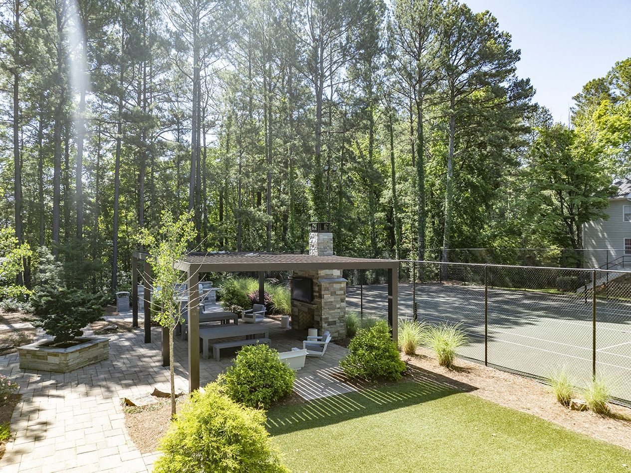 Outdoor community area with seating and tennis court