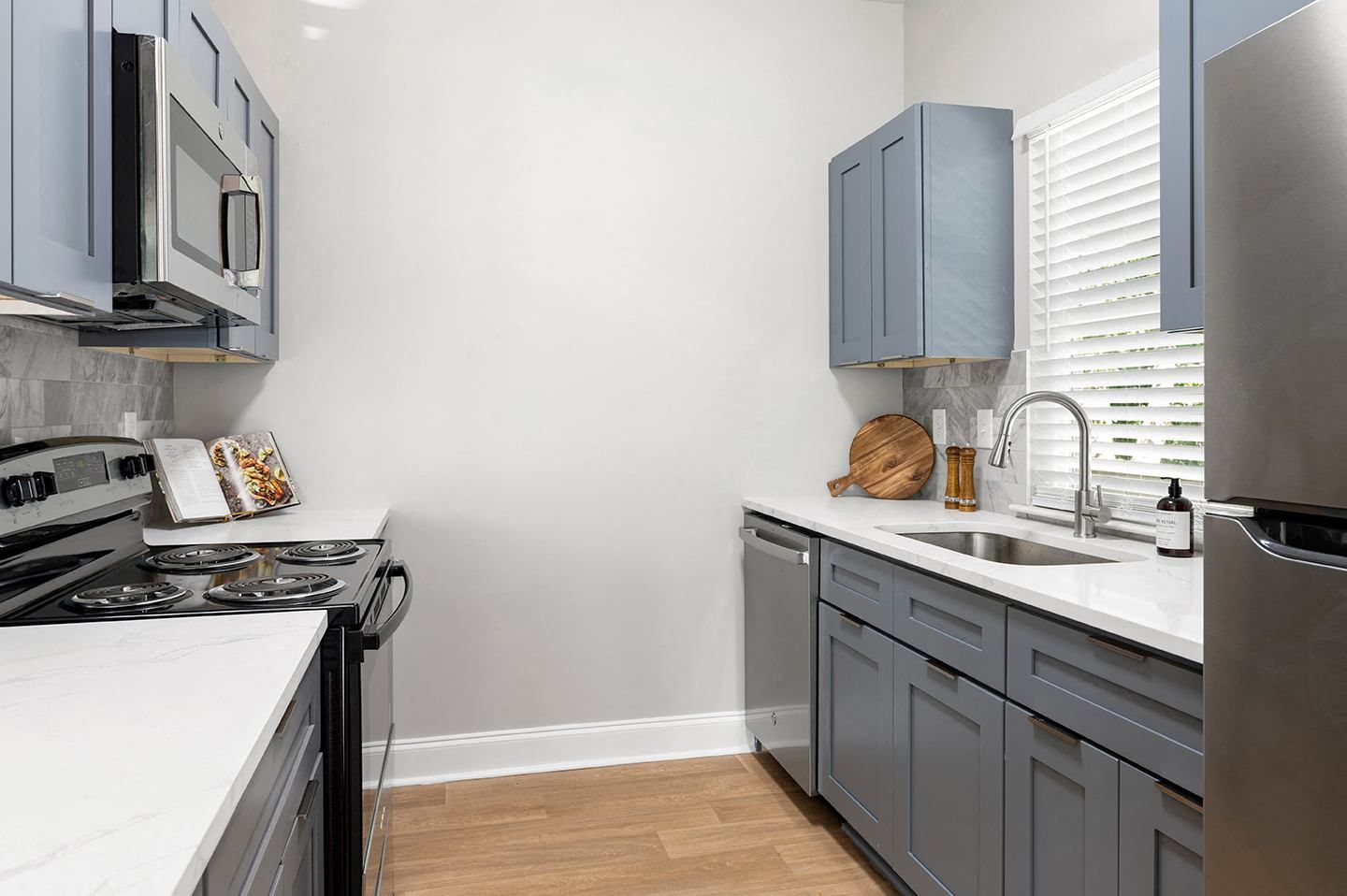Modern kitchen with blue cabinets and stainless steel appliances