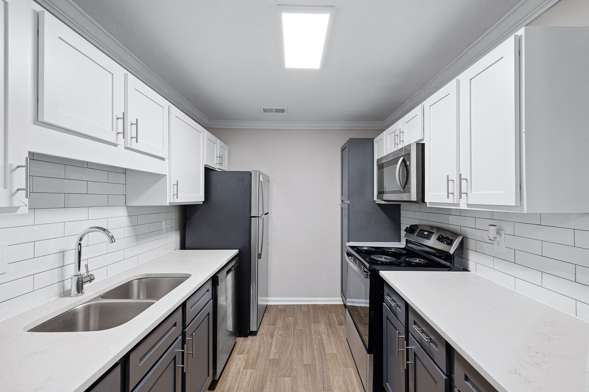 Modern kitchen with stainless steel appliances and white cabinetry