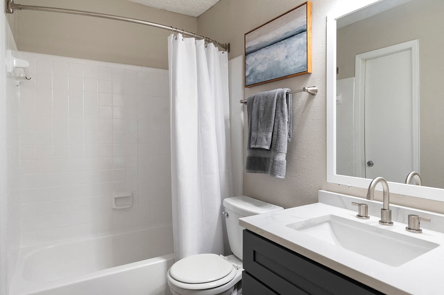 Modern bathroom with shower, toilet, and sink
