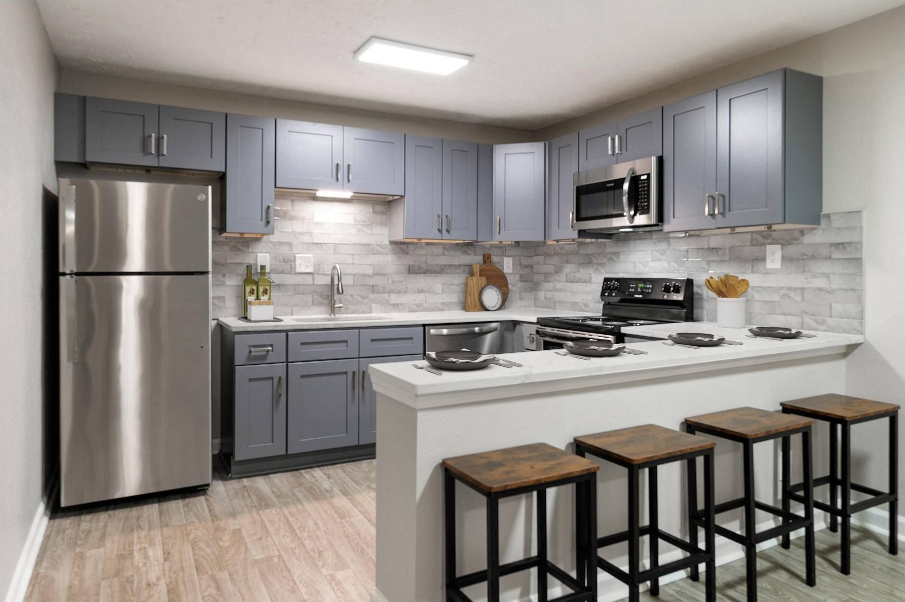 Modern kitchen with stainless steel appliances and blue cabinets