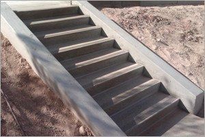 Concrete staircase leading upwards, set in dirt.