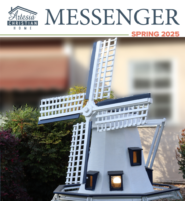 Cover: Artesia Christian Home Messenger Spring 2025. White windmill with blue accents in front of a building.