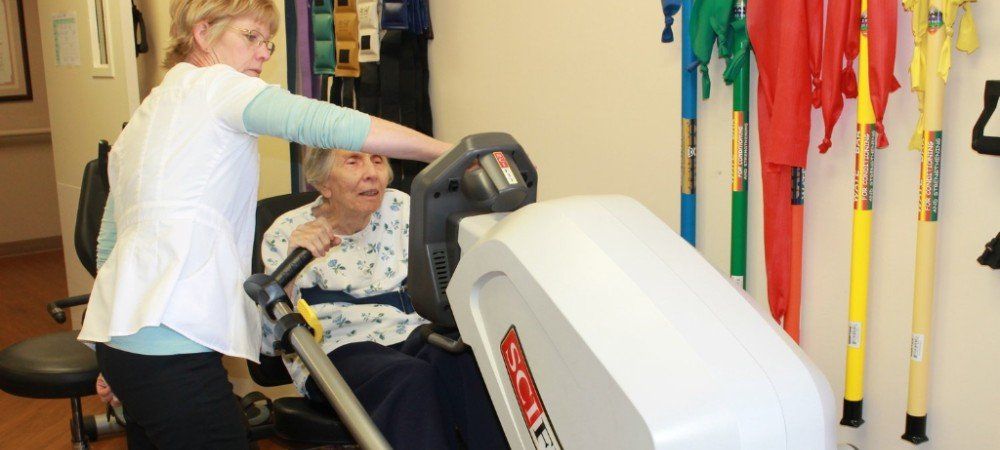 Elderly woman excising on a rehabilitation machine in Artesia, CA.
