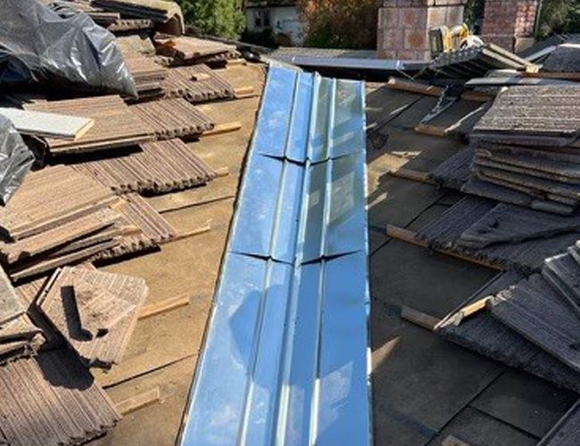 A metal gutter is being installed on the roof — Rio Linda, CA — M1 Roofing