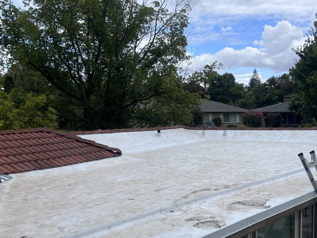 Men installing low slope roofing — Rio Linda, CA — M1 Roofing