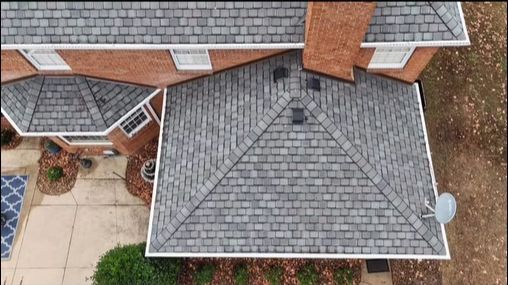 An aerial view of a house with a gray roof.