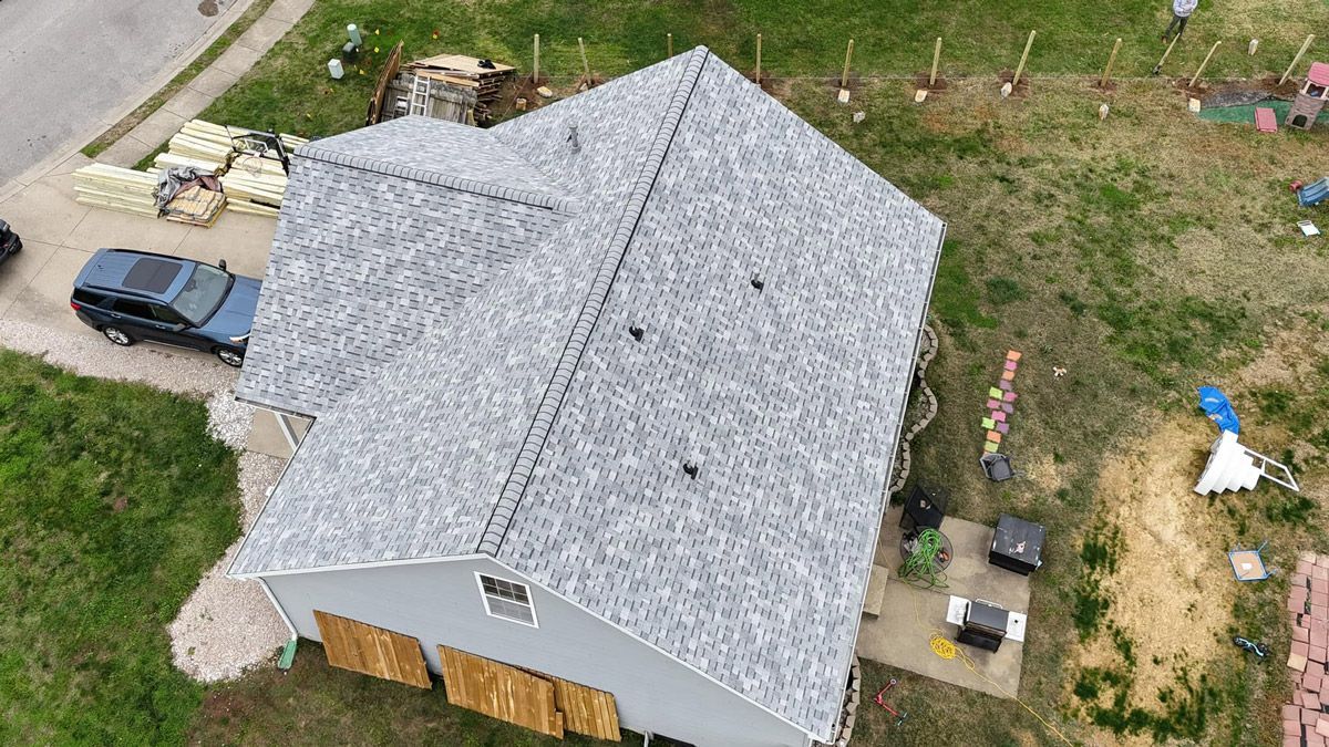 An aerial view of a house with a new roof.