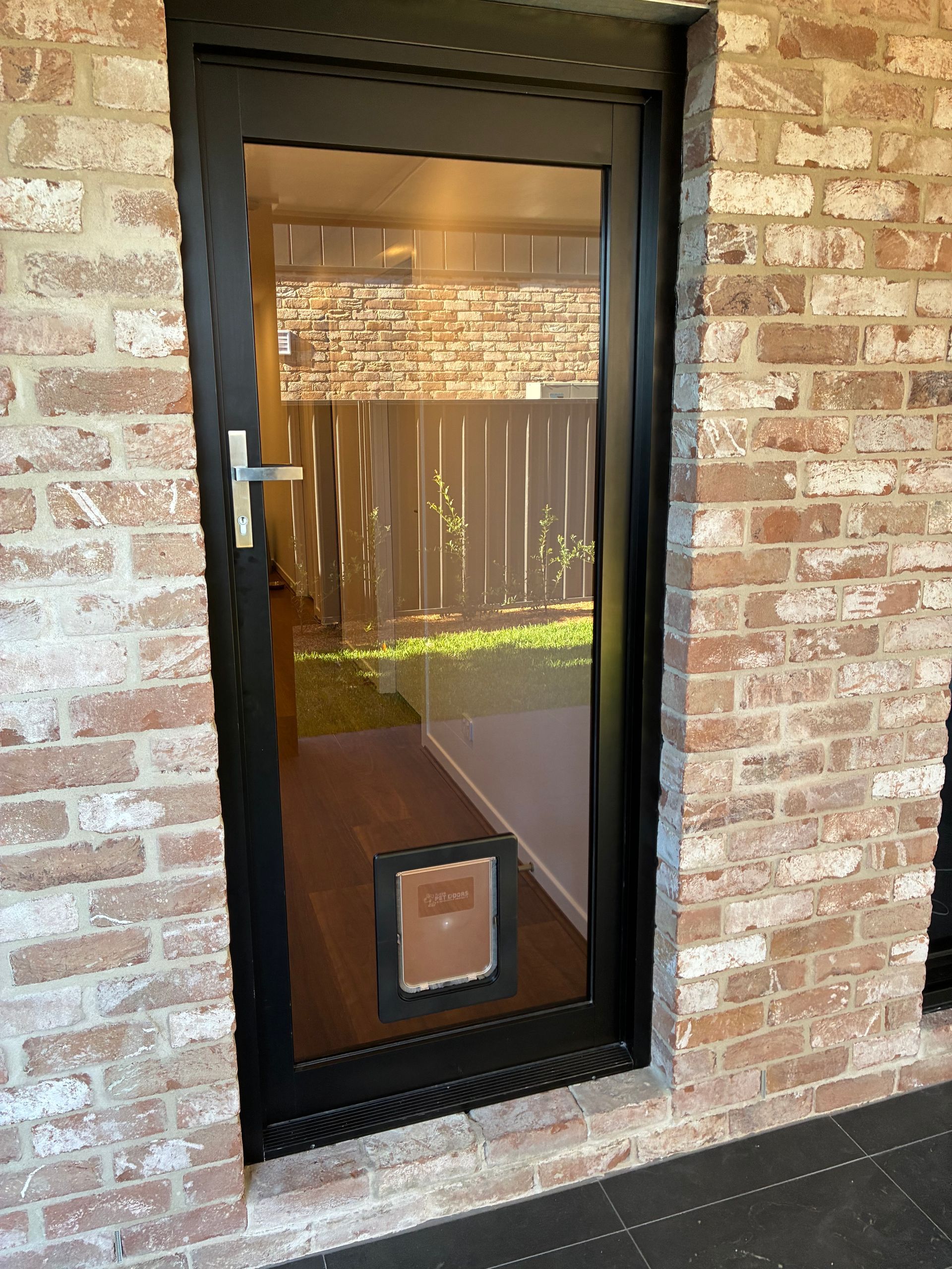 Pet Door installed on black door -Pelican Glass in Lake Macquarie, NSW