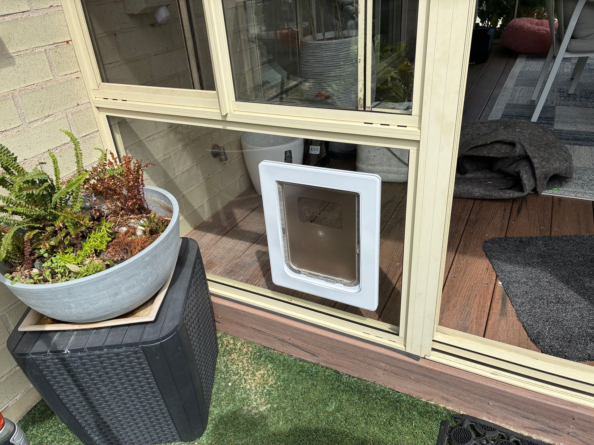 Pet door installed on window of backyard - Pelican Glass in Pelican, NSW