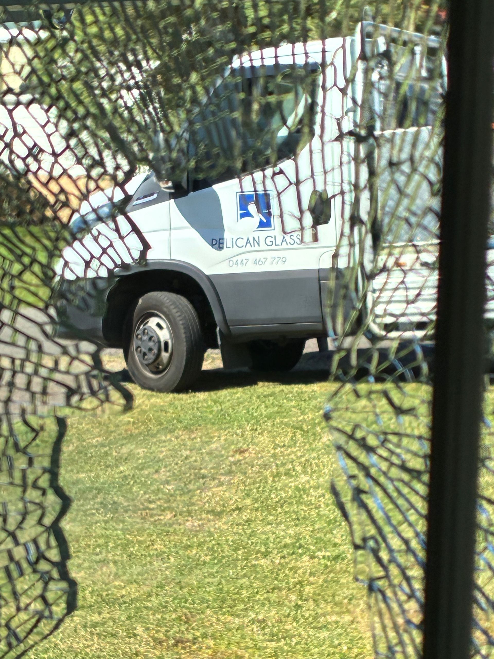 Cracked glass overlooking truck door with Pelican Glass logo - Pelican Glass in Lake Macquarie, NSW