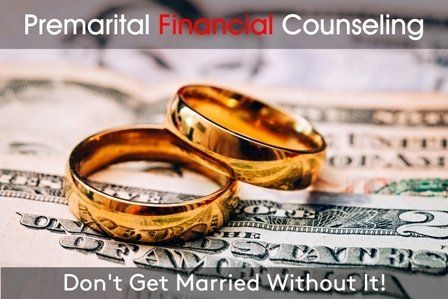 Two gold wedding rings are sitting on top of a dollar bill.